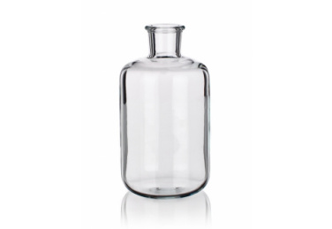 A clear, empty glass bottle with a cylindrical shape and a short, narrow neck is pictured against a plain white background. The bottle has a simple and clean design, with smooth, even surfaces and a subtle reflection at the base.