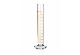 A glass graduated cylinder with yellow measurement markings from 0 to 500 milliliters, standing upright on a clear, hexagonal base.