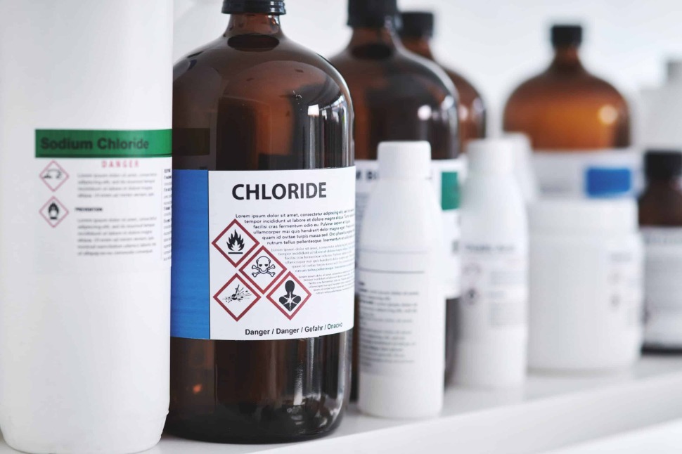 The image of laboratory materials inside standard glass bottles with a label containing technical specifications, including laboratory chloride, which includes risks and safety tips in the label.