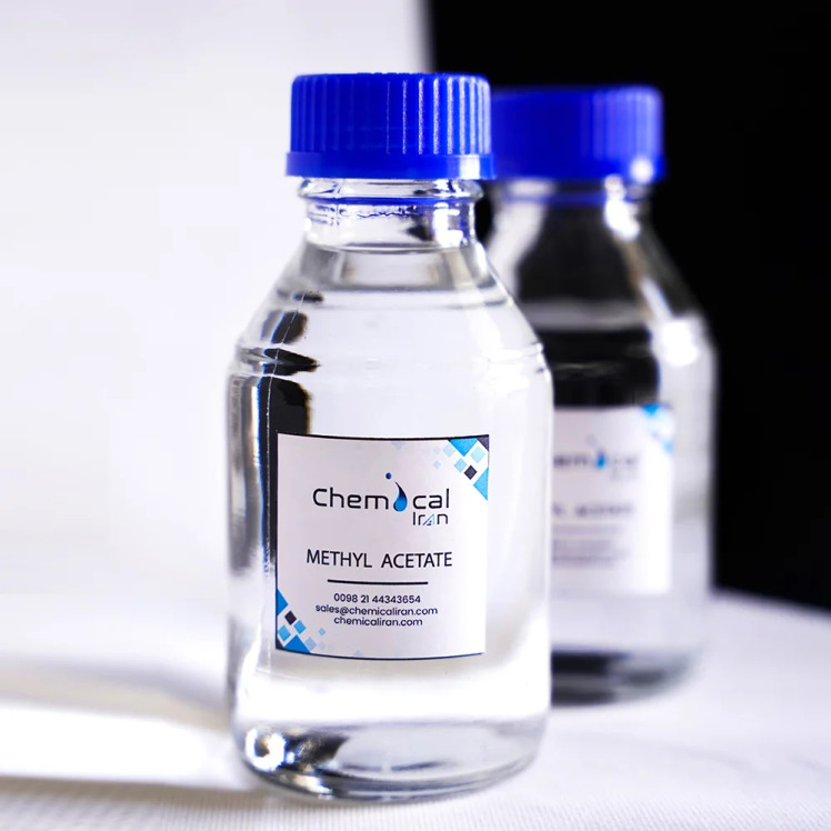 Industrial grade methyl acetate in a clear glass bottle with a blue cap