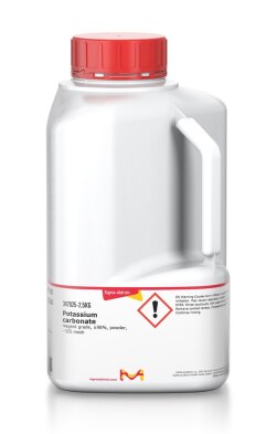 Sigma-Aldrich potassium carbonate in a white bottle with a red cap and a technical specification label